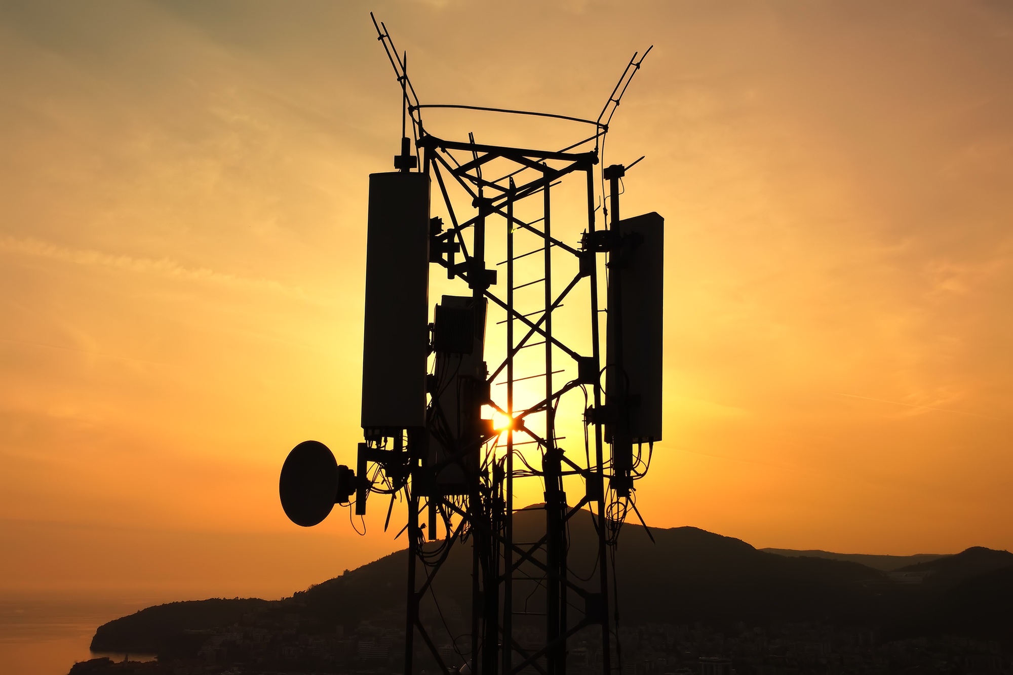 Amazing closeup sunset drone view of silhouette of cell tower